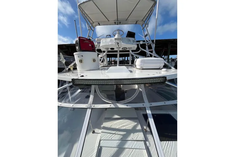 Slide: The Image of 2008 ProKat 3660 Sport Fish boat with upper deck and equipment under clear sky. - 17
