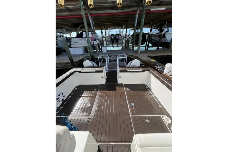 Slide: The Image of 2008 ProKat 3660 Sport Fish boat docked, featuring spacious deck and fishing amenities. - 4