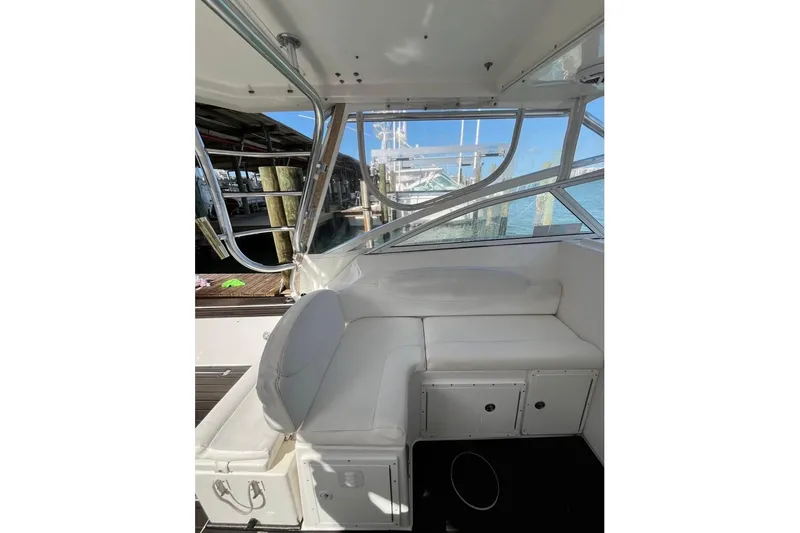 Slide: The Image of 2008 ProKat 3660 Sport Fish boat interior with white seating and dock view. - 6