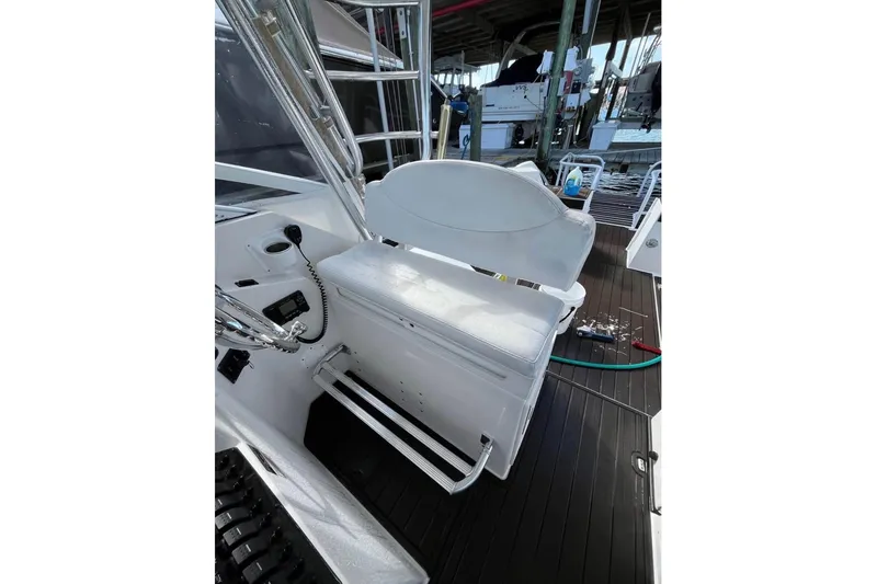 Slide: The Image of 2008 ProKat 3660 Sport Fish boat interior with white seating and control panel. - 8