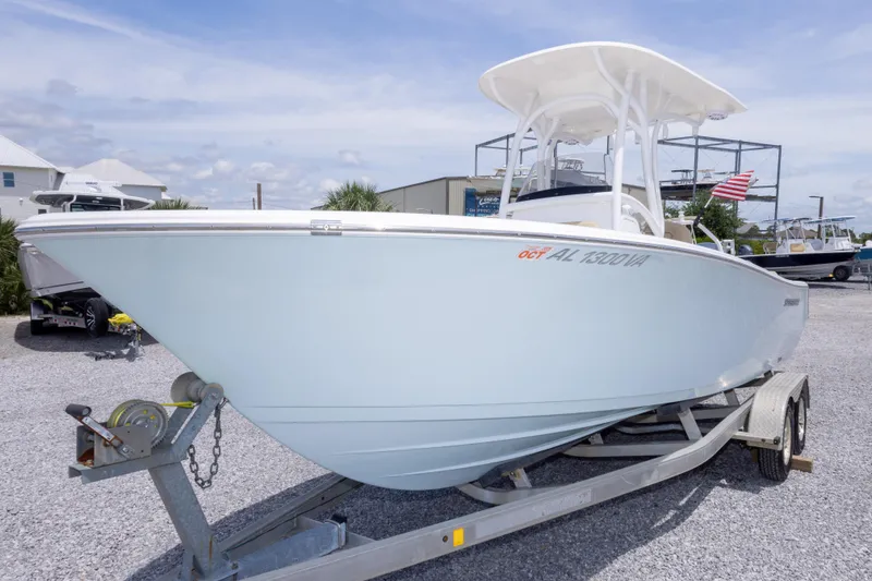 Slide: The Image of 2015 Sportsman Heritage 211 Center Console boat on trailer, displayed outdoors. - 14