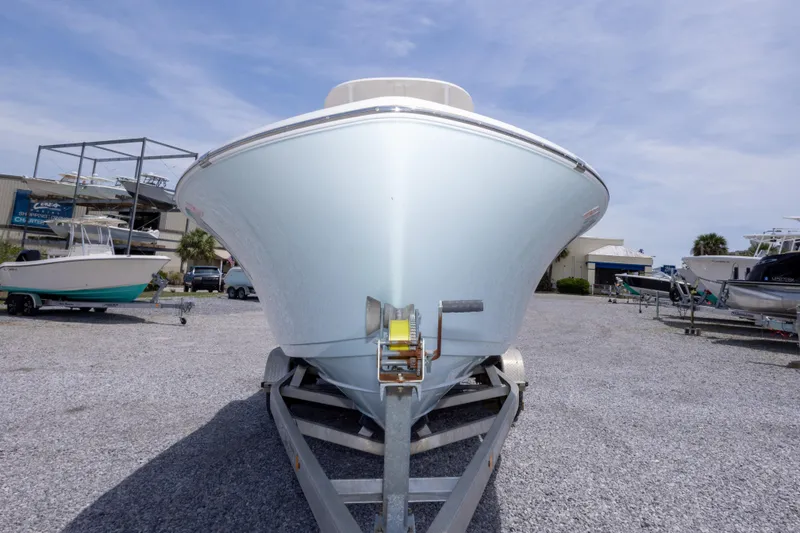 Slide: The Image of 2015 Sportsman Heritage 211 Center Console boat on trailer in marina. - 15