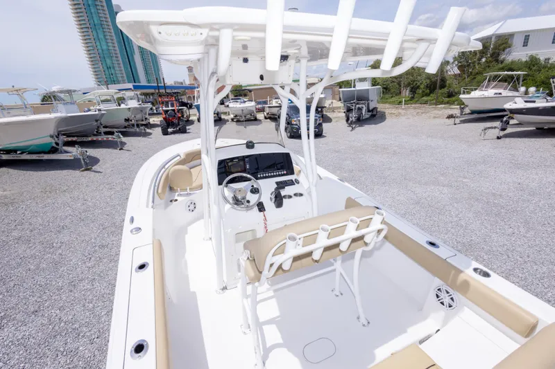 Slide: The Image of 2015 Sportsman Heritage 211 Center Console boat in a marina with other vessels. - 17