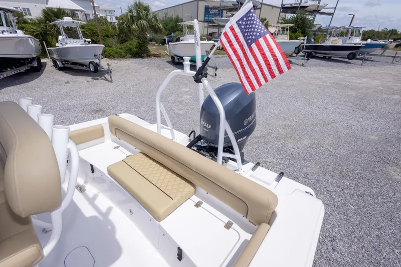 Slide: The Image of 2015 Sportsman Heritage 211 Center Console boat with American flag and Yamaha motor. - 21