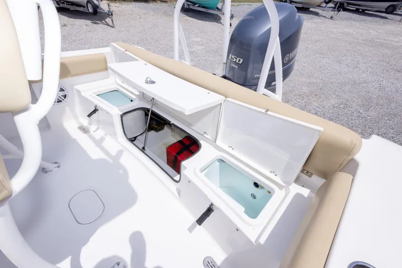 Slide: The Image of 2015 Sportsman Heritage 211 Center Console boat interior with storage compartments open. - 23