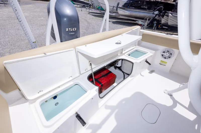 Slide: The Image of 2015 Sportsman Heritage 211 Center Console boat interior with storage compartments and Yamaha 150 engine. - 24