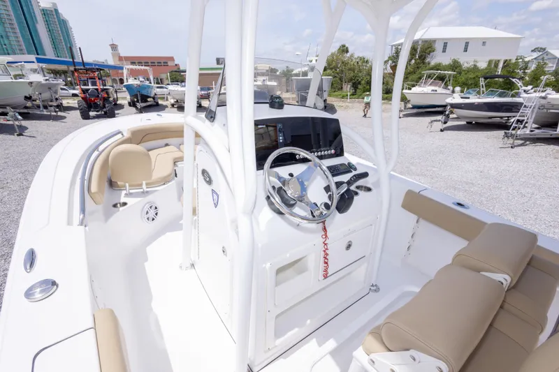 Slide: The Image of 2015 Sportsman Heritage 211 Center Console boat interior with steering wheel and seating. - 25