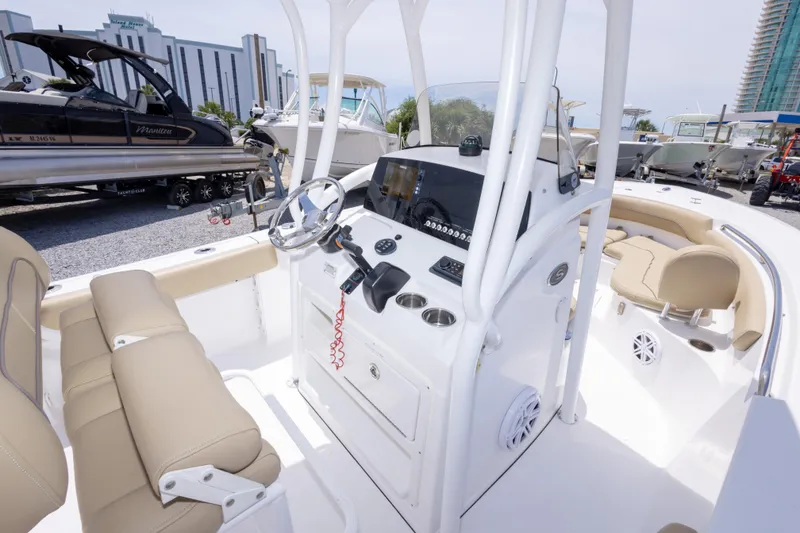 Slide: The Image of 2015 Sportsman Heritage 211 Center Console boat interior with steering wheel and seating. - 26