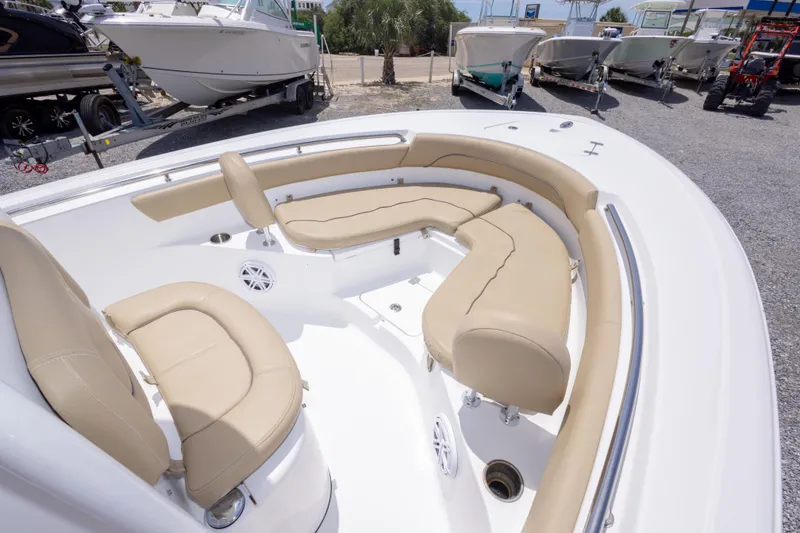 Slide: The Image of 2015 Sportsman Heritage 211 Center Console boat with beige seating, docked outdoors. - 28