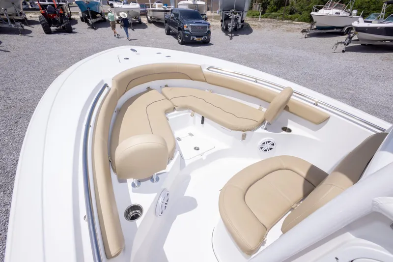 Slide: The Image of 2015 Sportsman Heritage 211 Center Console boat with beige seating in a gravel lot. - 29