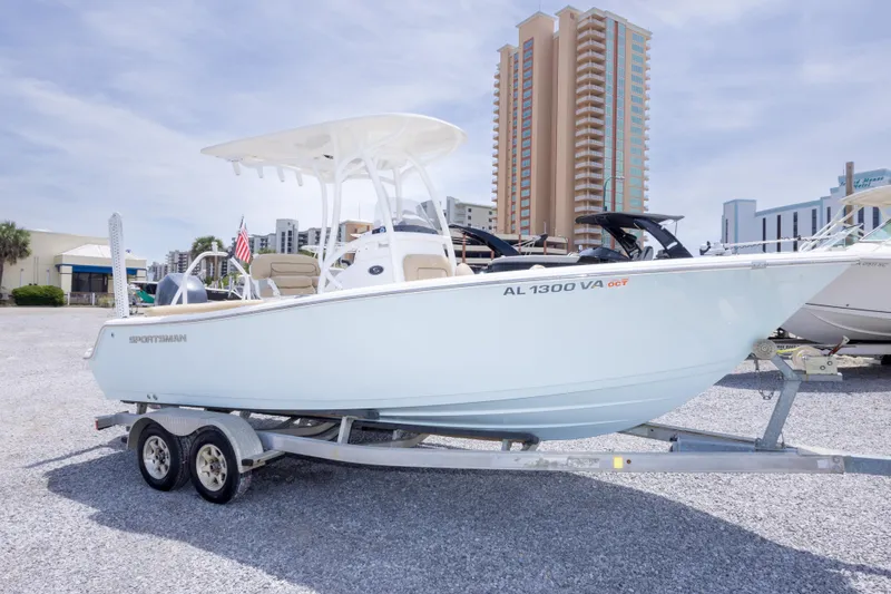 Slide: The Image of 2015 Sportsman Heritage 211 Center Console boat on trailer, urban backdrop. - 3