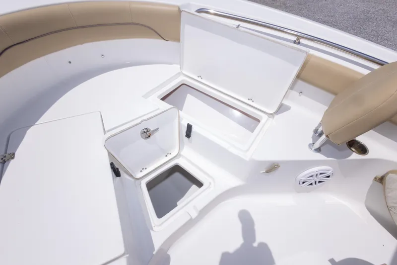 Slide: The Image of 2015 Sportsman Heritage 211 Center Console boat interior with open storage compartments. - 34