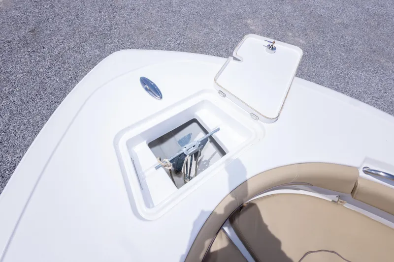 Slide: The Image of 2015 Sportsman Heritage 211 Center Console anchor storage with open hatch and seating area. - 36