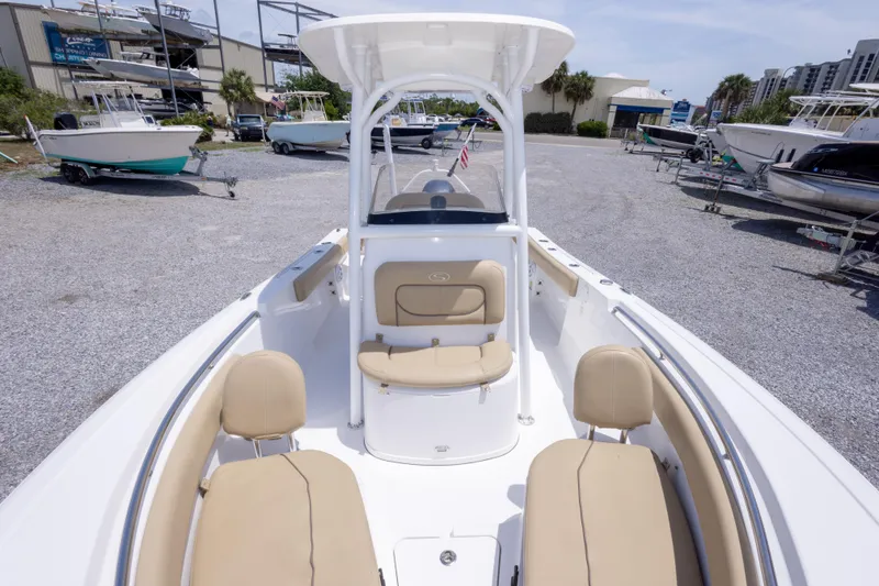 Slide: The Image of 2015 Sportsman Heritage 211 Center Console boat with beige seating, parked in a marina. - 37