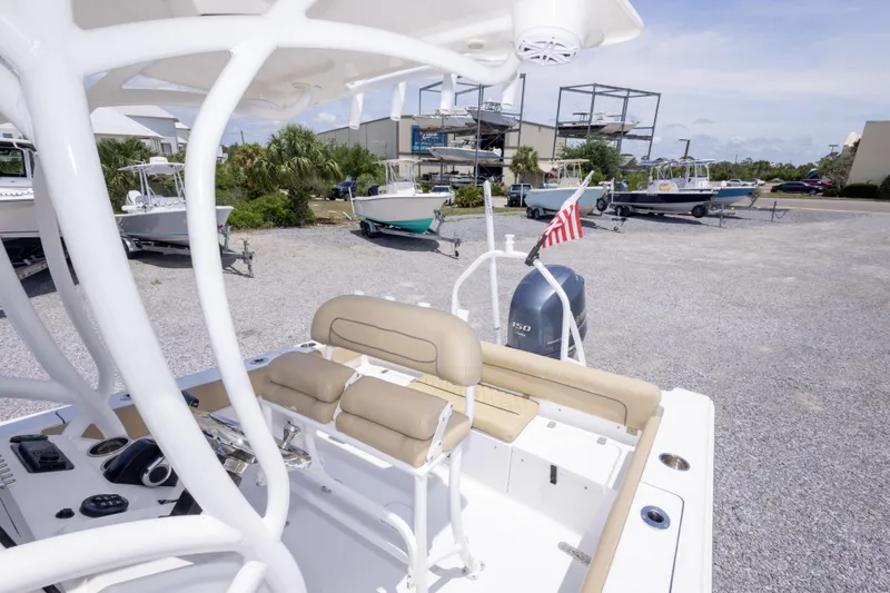 Slide: The Image of 2015 Sportsman Heritage 211 Center Console boat with seating, parked in a marina lot. - 38
