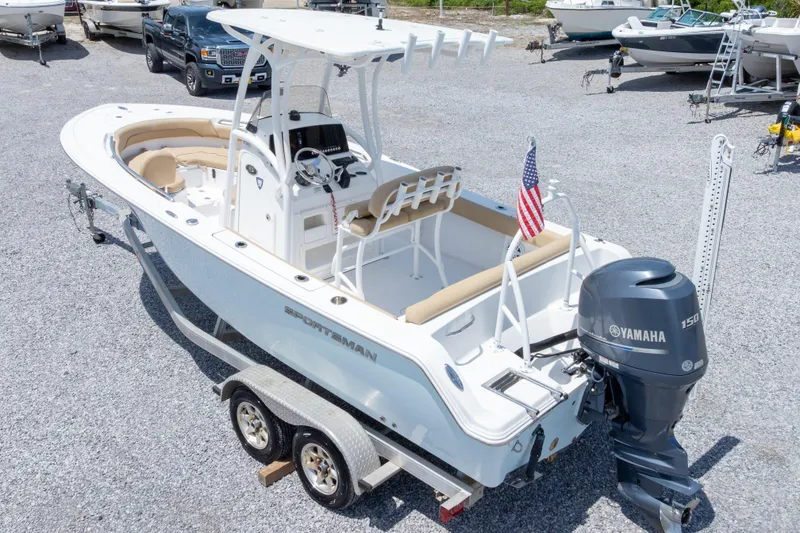 Slide: The Image of 2015 Sportsman Heritage 211 Center Console boat with Yamaha 150 engine on trailer. - 45