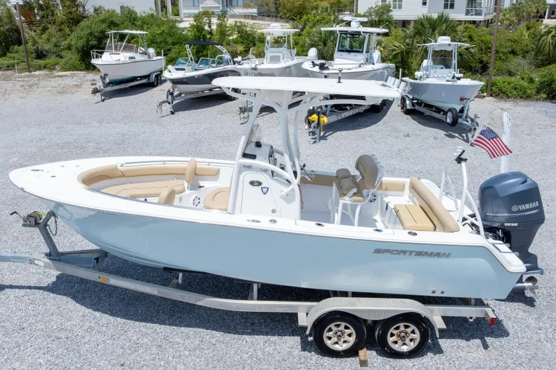 Slide: The Image of 2015 Sportsman Heritage 211 Center Console boat on trailer, surrounded by other boats. - 47