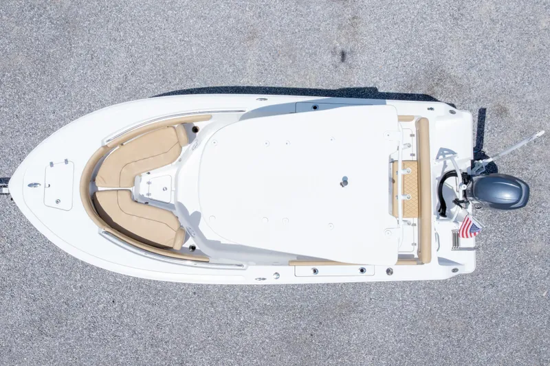 Slide: The Image of Overhead view of a 2015 Sportsman Heritage 211 Center Console boat on a textured surface. - 6