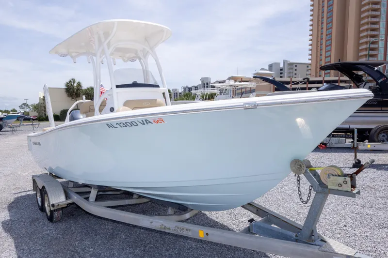 Slide: The Image of 2015 Sportsman Heritage 211 Center Console boat on trailer in marina setting. - 9