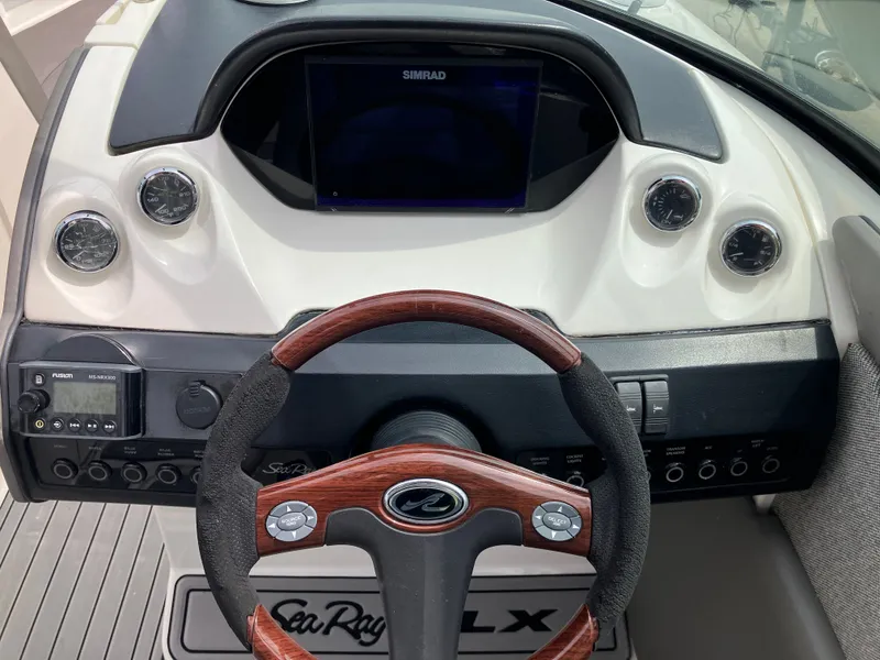 Slide: The Image of Dashboard of a 2008 Sea Ray 270 SLX boat with wooden steering wheel. - 22