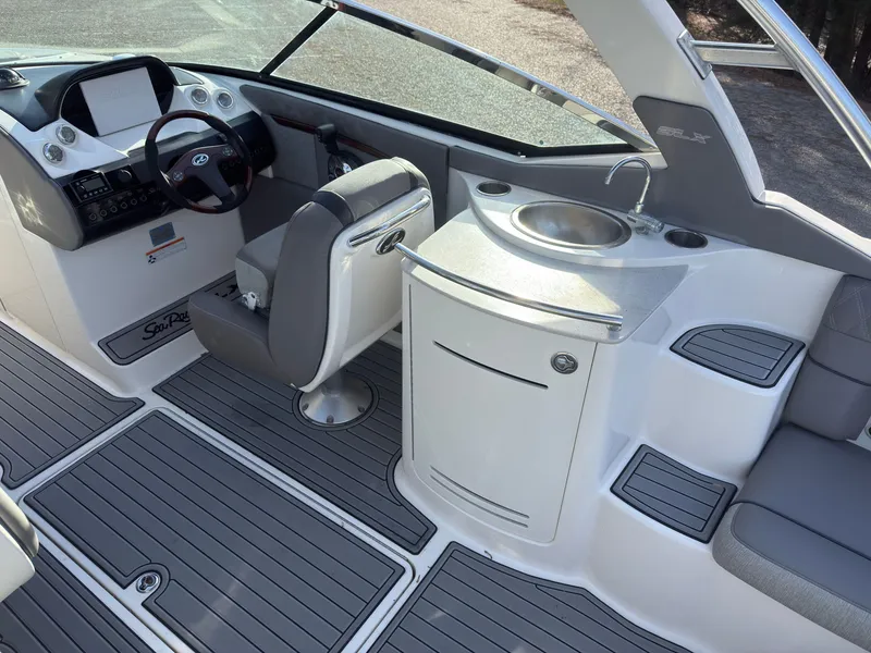 Slide: The Image of Interior of a 2008 Sea Ray 270 SLX with helm and sink. - 9