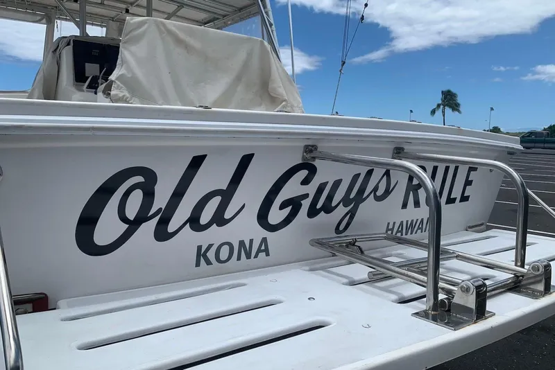 Slide: The Image of 2006 Strike 29 CC boat with "Old Guys Rule" text, Kona, Hawaii backdrop. - 10