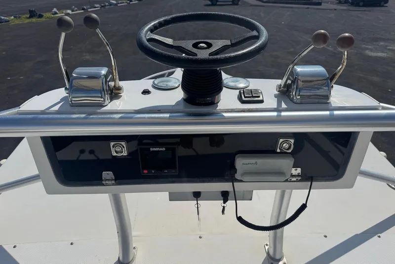 Slide: The Image of 2006 Strike 29 CC boat helm with steering wheel and controls. - 12