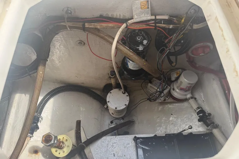 Slide: The Image of Engine compartment of a 2006 Strike 29 CC boat, showing wiring and mechanical components. - 17
