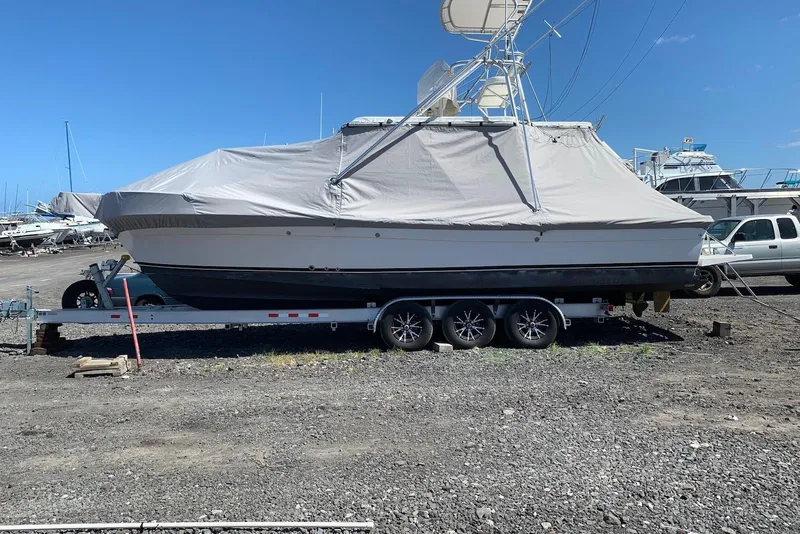 Slide: The Image of Covered 2006 Strike 29 CC boat on a trailer in a boatyard. - 20