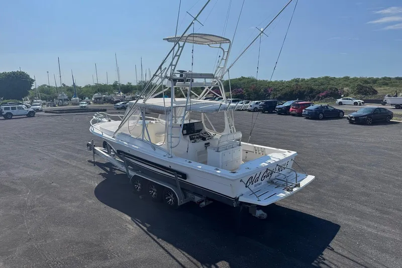 Slide: The Image of 2006 Strike 29 CC boat on trailer in parking lot under clear sky. - 8