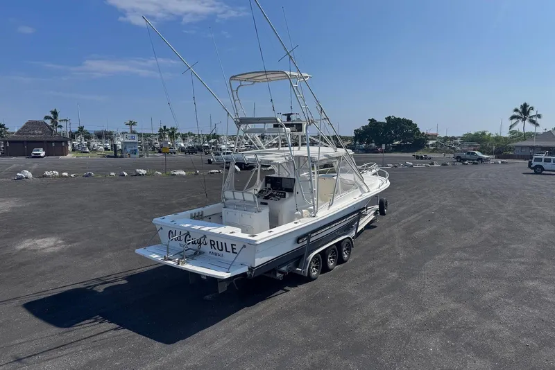 Slide: The Image of 2006 Strike 29 CC boat on trailer in sunny parking lot. - 9