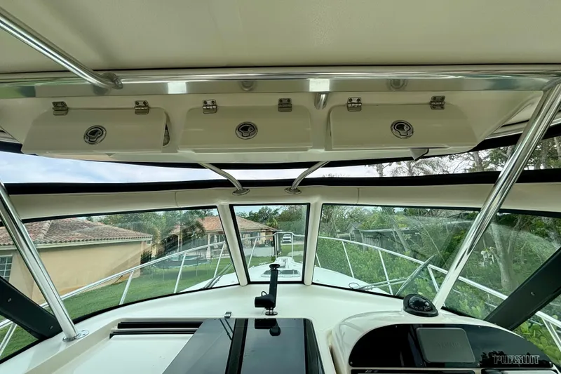 Slide: The Image of Interior view of 2007 Pursuit 3370 Offshore boat cockpit with overhead storage. - 11