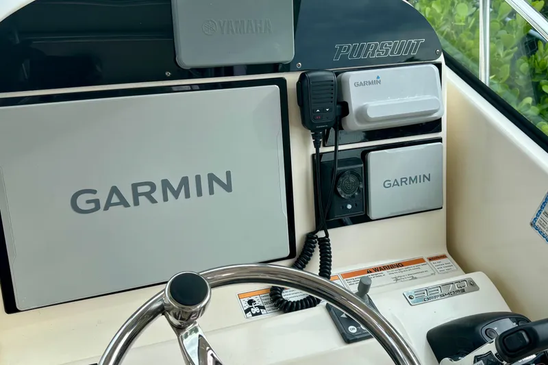 Slide: The Image of Helm of 2007 Pursuit 3370 Offshore boat with Garmin navigation equipment. - 12