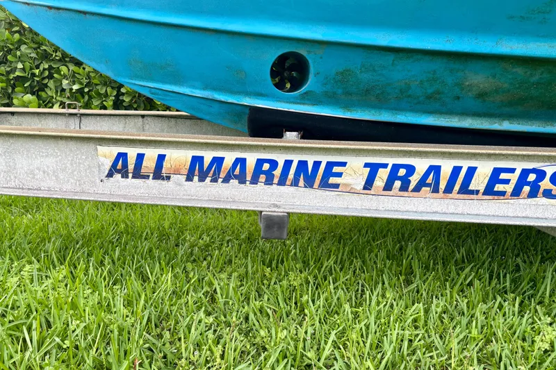 Slide: The Image of Trailer with Pursuit 3370 Offshore boat, 2007 model, on grass. - 17
