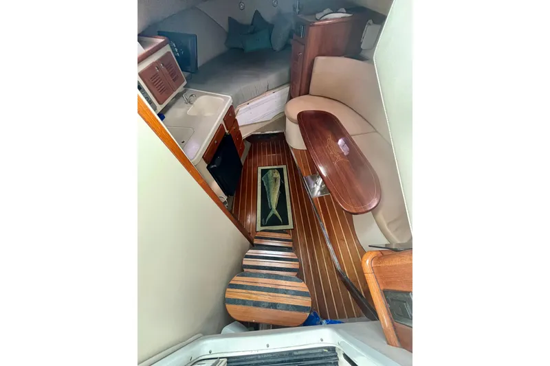 Slide: The Image of 2007 Pursuit 3370 Offshore cabin interior with wood flooring and seating area. - 7