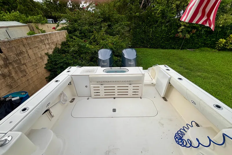 Slide: The Image of 2007 Pursuit 3370 Offshore boat deck with twin engines and American flag. - 9