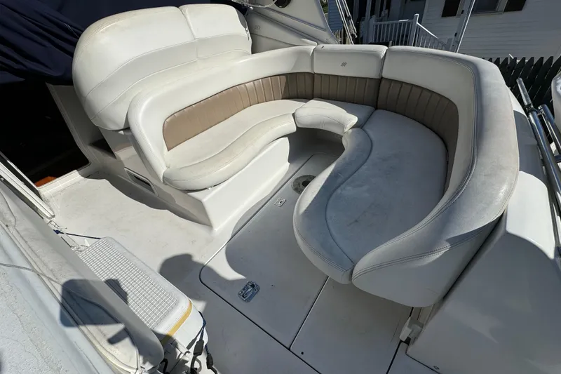 Slide: The Image of 2004 Four Winns 268 Vista boat interior with curved seating and white upholstery. - 10