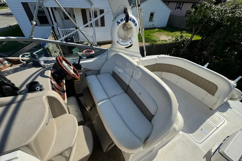 Slide: The Image of 2004 Four Winns 268 Vista boat interior with white seating and steering wheel. - 15