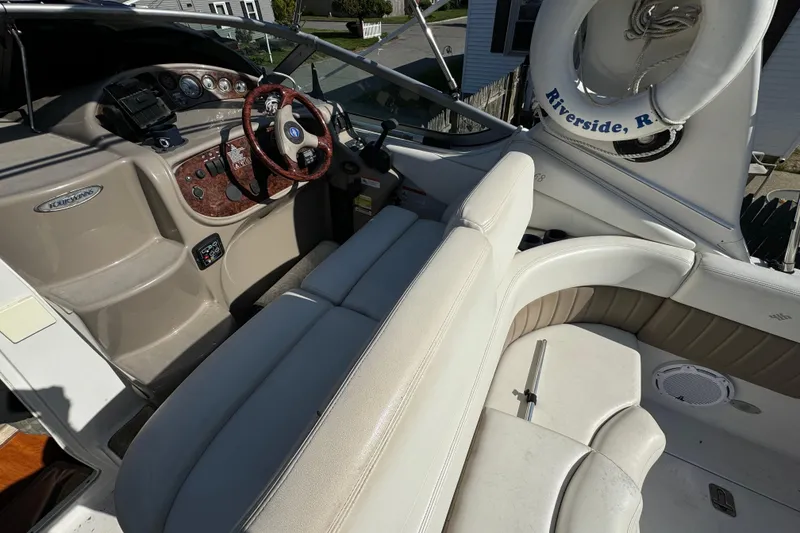 Slide: The Image of 2004 Four Winns 268 Vista boat interior with steering wheel and seating area. - 17