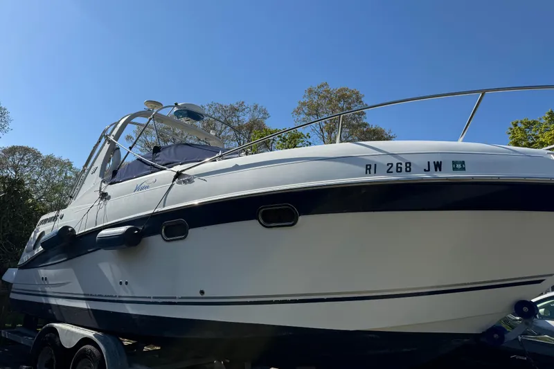 Slide: The Image of 2004 Four Winns 268 Vista boat on trailer under clear blue sky. - 18