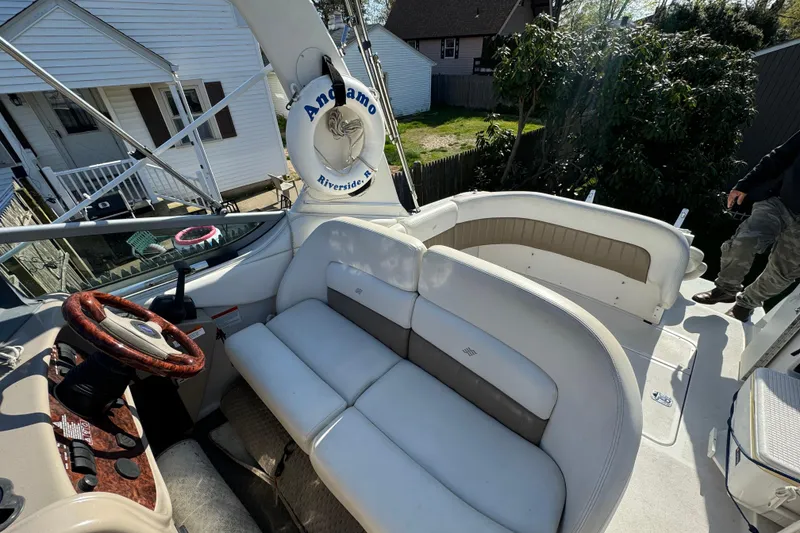 Slide: The Image of 2004 Four Winns 268 Vista boat interior with seating and steering wheel. - 5