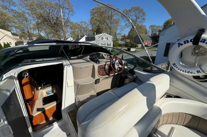Slide: The Image of 2004 Four Winns 268 Vista boat interior with steering wheel and seating area. - 8