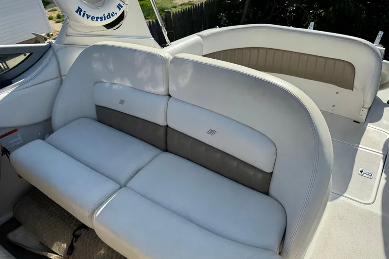 Slide: The Image of 2004 Four Winns 268 Vista boat interior with white cushioned seating. - 9