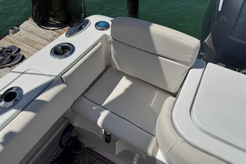 Slide: The Image of 2023 Sea Hunt Gamefish 27 boat seating area with cup holders, dockside view. - 11