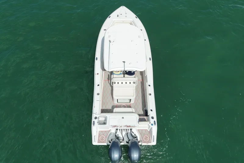 Slide: The Image of 2023 Sea Hunt Gamefish 27 boat with forward seating on open water. - 2