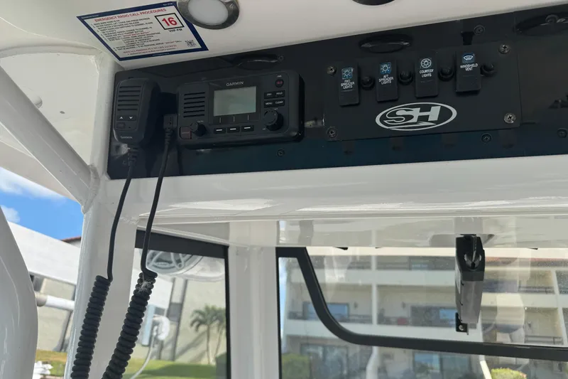 Slide: The Image of Control panel of 2023 Sea Hunt Gamefish 27 boat with Garmin radio and switches. - 22