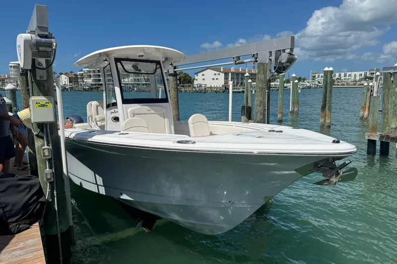Slide: The Image of 2023 Sea Hunt Gamefish 27 boat docked, featuring forward seating and sleek design. - 3