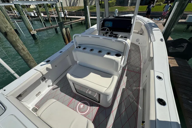 Slide: The Image of 2023 Sea Hunt Gamefish 27 boat with forward seating, docked at marina. - 5