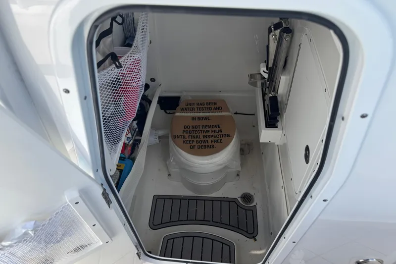 Slide: The Image of 2023 Sea Hunt Gamefish 27 boat interior with toilet and storage compartments. - 7