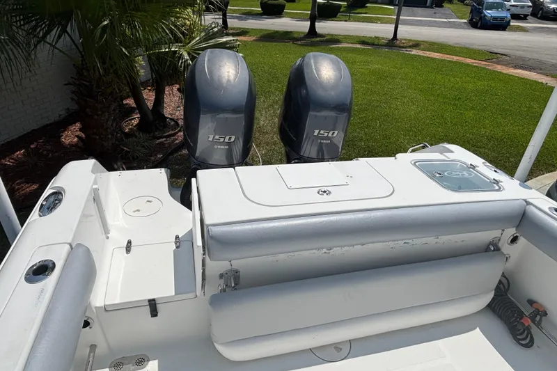Slide: The Image of 2011 Sea Hunt Gamefish 25 boat with twin Yamaha 150 engines, parked on grass. - 4